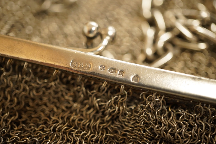 A George V silver mesh evening bag, import marks for Paul Ettlinger, London, 1932, a similar small evening purse, import marks for London, 1919 and two other white metal mesh evening bags or purses, one stamped sterling.